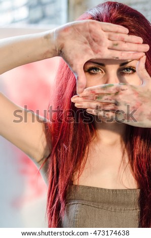 Girl artist showing dirty hands, painter copies gestures with his hands