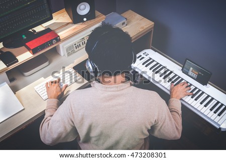 music composer making songs in recording studio Royalty-Free Stock Photo #473208301