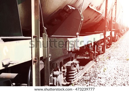Railroad train of black tanker cars transporting crude oil on the tracks, with instagram effect