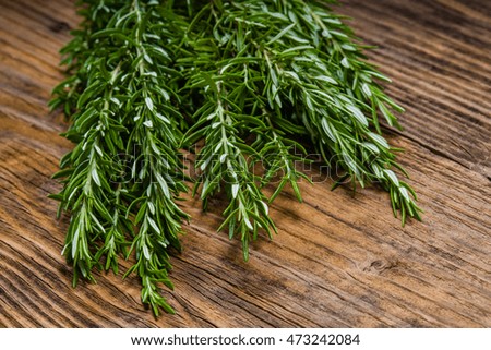 Freshly picked bundle of rosemary on a wooden table