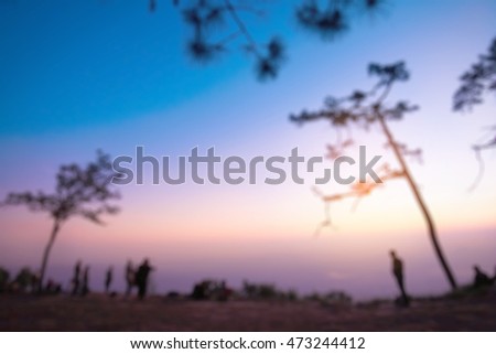 Blurred landscape of sunset with violet sky and sillouette of pine tree and people, Phu Kradueng National Park  Thailand.