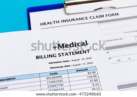 Health care cost concept with medical bill and health insurance claim form