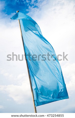 Colorful flags are swaying in the breeze on a summer day