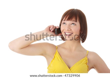 Young caucasian woman in yellow dress using a mobile phone isolated