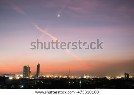 Beautiful Cityscape Sunset with Crescent Moon. Low key