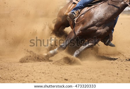 A front view of a horse galloping and sliding in the dirt. Royalty-Free Stock Photo #473320333