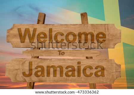 Welcome to Jamaica sign on wood background with blending national flag