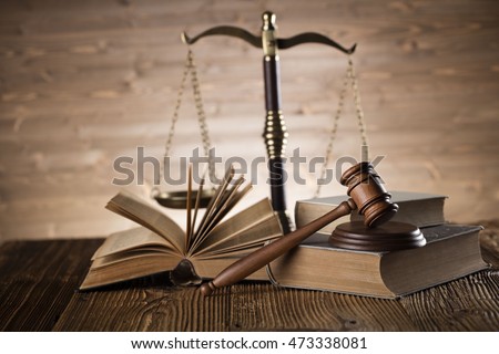 Law theme, bronze and gold scales of justice, books, wooden mallet, statue of justice, on wooden table, . Brown wooden background, studio shots