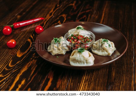 A dish in the plate on the wooden background