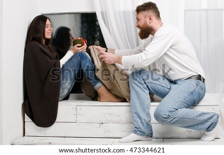 Man closes woman legs knitted blanket