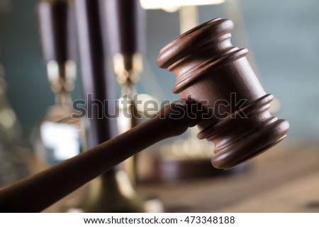 Law and justice theme, handcuffs, statue of justice, golden scales of justice, gavel and  magnifying glass, on pale-green background. Law code