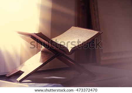 The holy book of the Koran on the stand . Royalty-Free Stock Photo #473372470