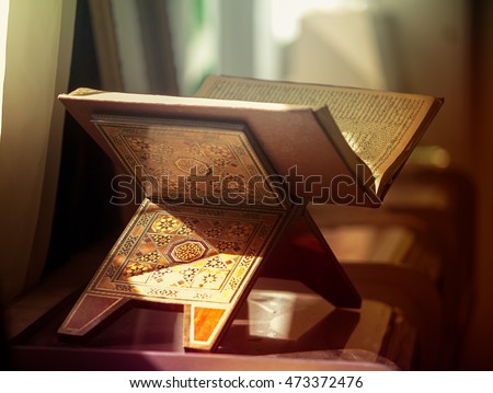 The holy book of the Koran on the stand . Royalty-Free Stock Photo #473372476