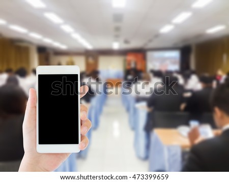 woman use mobile phone and blurred image of people in the conference room