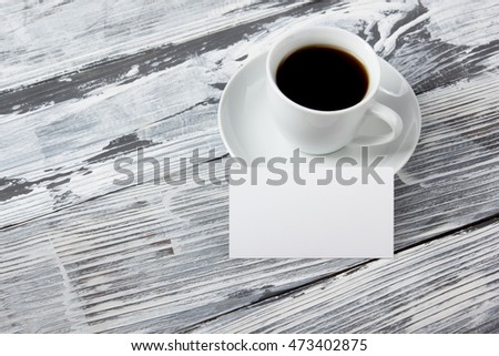 Photo blank b-cards with cup of coffee on a wooden texture. Copy space for your ad.