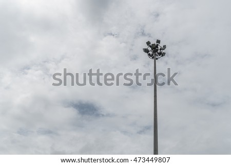 Spot light pole on dark cloud background