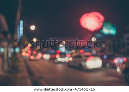vintage tone blur image of car on street with firework in background night time.