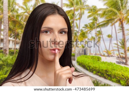 woman showing silence gesture