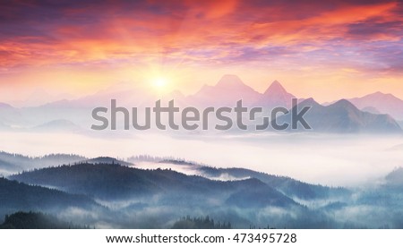  sunrise, the sun's rays illuminate the beautiful panorama of the Carpathian village against backdrop of scenic mountains, where the highlanders live Hutsul. Wild forests, fields pastures