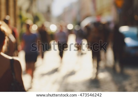 Crowded blurred street in Europe. Blurred unrecognizable people background.