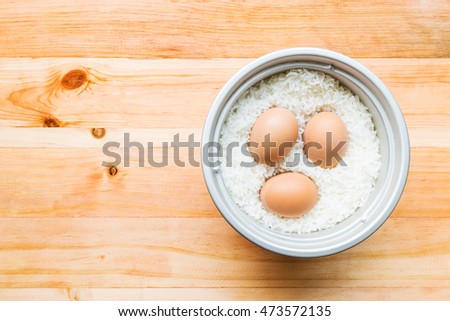 Picture of boiled eggs  by the electric rice cooker on wood table, Thailand, Asia