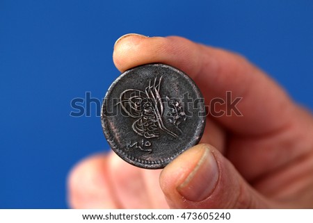 picture of a Fingers hold old coin from Ottoman empire
