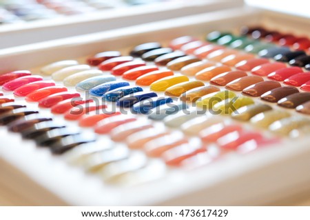 colorful artificial nails on shelves in beauty shop  Royalty-Free Stock Photo #473617429