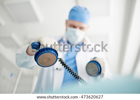 Reanimation with defibrillator Royalty-Free Stock Photo #473620627