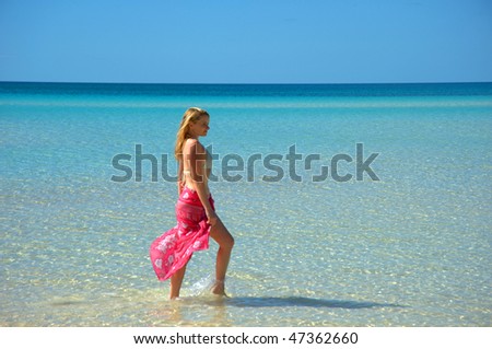 Blonde woman looking out to the Caribbean sea