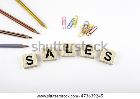 Text: Sales from wooden letterson on white office desk