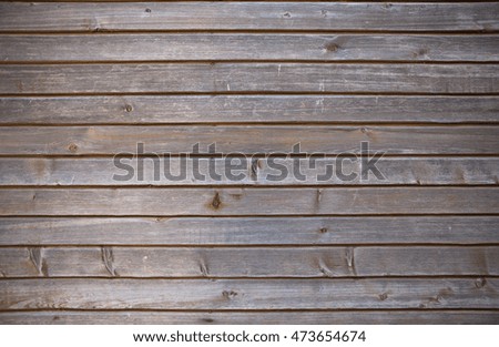 Background of aged and weathered dark grey wooden planking with traces of seagull droppings