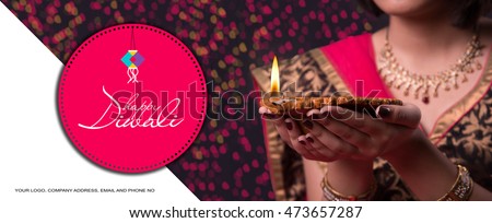 Happy Diwali Greeting card showing indian beautiful Girl holding a diya over black background Royalty-Free Stock Photo #473657287