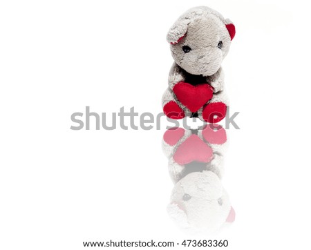 Vintage Home Made Teddy Bear holding red color love heart isolated on white background, Concept of Christmas and Valentine's Day.