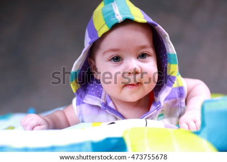 Little girl on a game rug