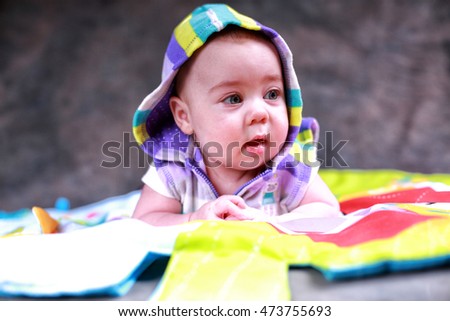 Little girl on a game rug