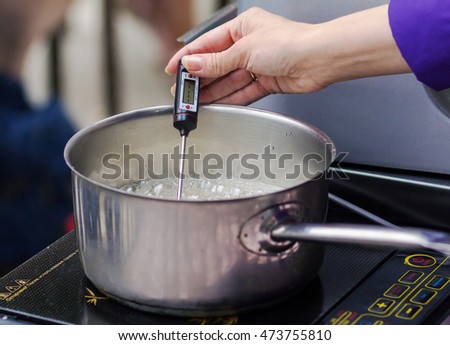  a master class in cooking caramel on a hotplate / caramel cooking  Royalty-Free Stock Photo #473755810