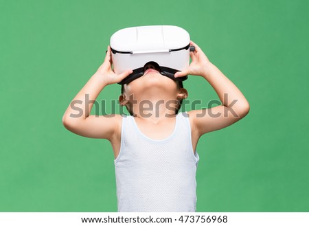 Little boy wearing virtual reality device