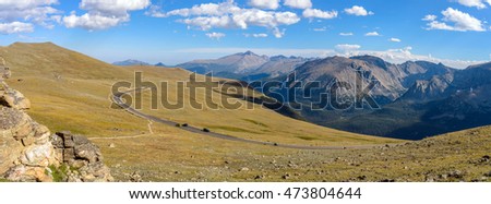 Trail Ridge Road - A panoramic view of Trail Ridge Road winding through vast alpine tundra at top of Rocky Mountain National Park, with Longs Peak (14,255 ft) rising high in background, Colorado, USA. Royalty-Free Stock Photo #473804644