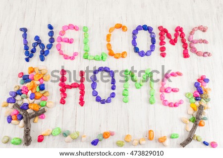 Welcome home note written with small colorful rocks