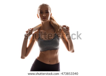 Beautiful sportive girl holding towel, posing over white background.