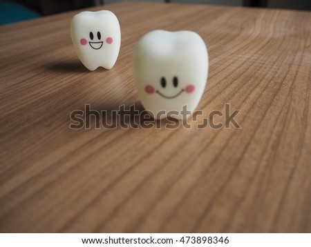 Emotion plastic tooth models on wooden background.