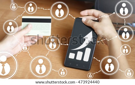 businessman keep smart phone with chart sign. Smartphone with graph icon in one hand and credit card in other hand. Diagram in business, revenue, concept,  communication. Bank card, stock, network.