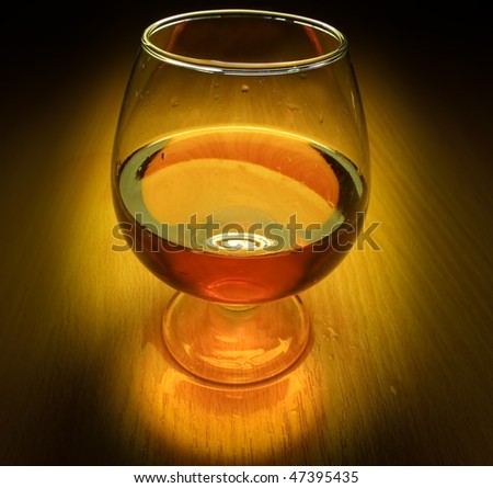 Glass of brandy with light on dark