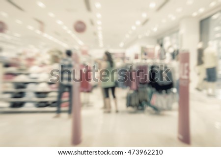 Abstract blurred image of shopping mall and people for background usage .