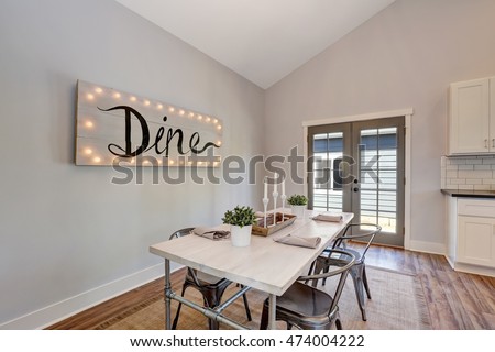 View of dining table with wooden top and metal chairs. French doors lead out to the back yard. Northwest, USA