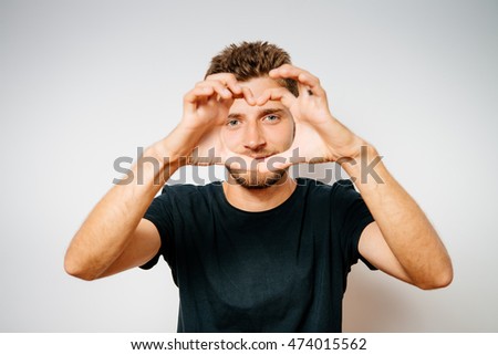 man making a hand heart frame