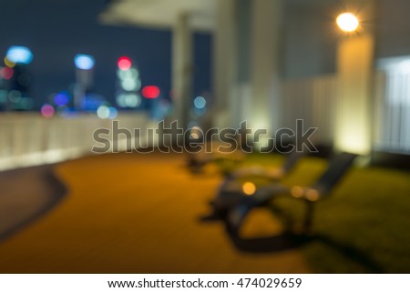 Abstract blur daybed in night garden with city view background