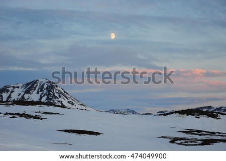 Iceland landscape during twilight winter with the moon in background.
