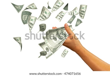 hand taking falling dollars