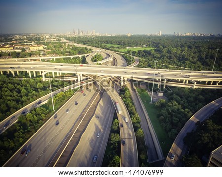 Aerial view interstate 10, Katy freeway and downtown with massive intersection, stack interchange, elevated road junction overpass at late afternoon from the west side of Houston, Texas, US. Vintage.